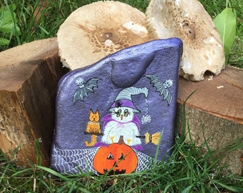 Halloween snowy owl with broom and cat on pumpkin with bats "Pebble Art" hand-painted on a natural stone.