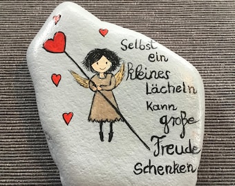 Guardian angel for you "Even a small smile can bring great joy," immortalized on a flat river stone