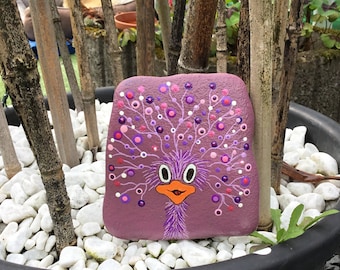 A funny ostrich painted in dotting technique on a natural stone/river stone in violet tones.
