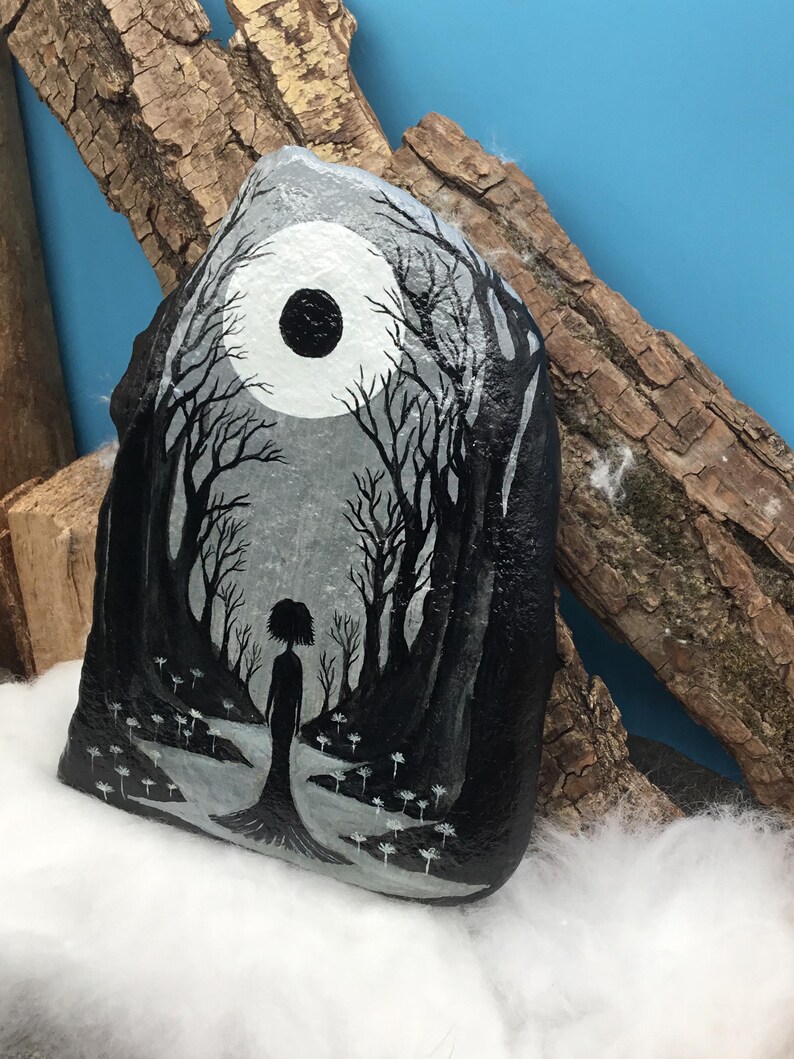 May include: Hand-painted rock art featuring a grayscale forest scene with a silhouetted figure. A large white moon with a black center dominates the sky. The artwork includes detailed trees and a path, creating a mystical, fantasy theme.