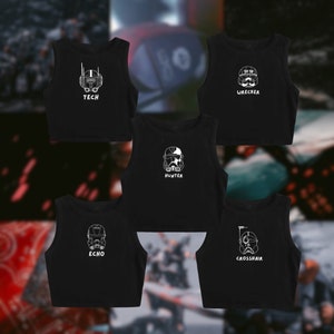 May include: Five black crop tops with white character designs and text. Each top features a different character design: Tech, Wrecker, Hunter, Echo, and Crosshair. The tops are sleeveless and have a scoop neck.