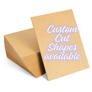 May include: A stack of brown cardboard sheets with the text "Custom Cut Shapes available" printed on the top sheet.