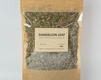 May include: A brown paper bag with a clear window, filled with dried dandelion leaf. The label reads "DANDELION LEAF" and indicates a net weight of 50g. The bag is sealed and ready for use.