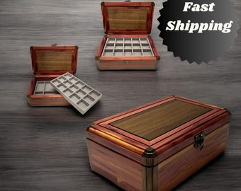 May include: Three wooden boxes with a cedar wood finish. The boxes have a hinged lid and a brass latch. The box on the left is open and has a gray felt insert with compartments. The box in the middle is open and has a gray felt insert with compartments. The box on the right is closed.