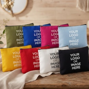 May include: A collection of eight rectangular canvas zipper pouches in olive green, blue, magenta, light blue, yellow, red, white, and black. Each pouch features the white printed text YOUR LOGO OR IMAGE HERE centered on the front surface.
