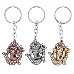 May include: Three silver keyrings with a silver, gold, and copper coloured elephant head charm. Each charm has a red jewel for the elephant's eye and is decorated with rhinestones.