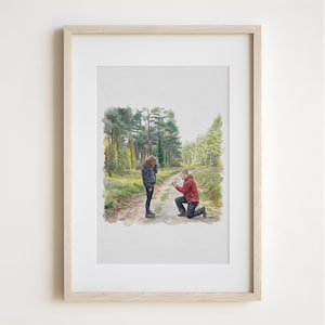 May include: Watercolor painting of a marriage proposal scene in a forest. A person kneels, presenting a ring to another person standing on a path. The artwork is framed in a light wood frame.