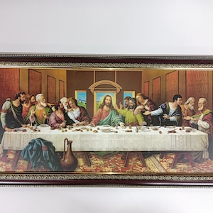 May include: A framed painting depicting The Last Supper, a famous biblical scene. The painting features Jesus Christ and his disciples gathered around a table, with a detailed background and a gold frame.