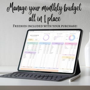 May include: A digital tablet displaying a monthly budget spreadsheet. The screen shows colorful charts and data fields for financial tracking. Text at the top reads "Manage your monthly budget all in 1 place." A keyboard and stylus are also visible.