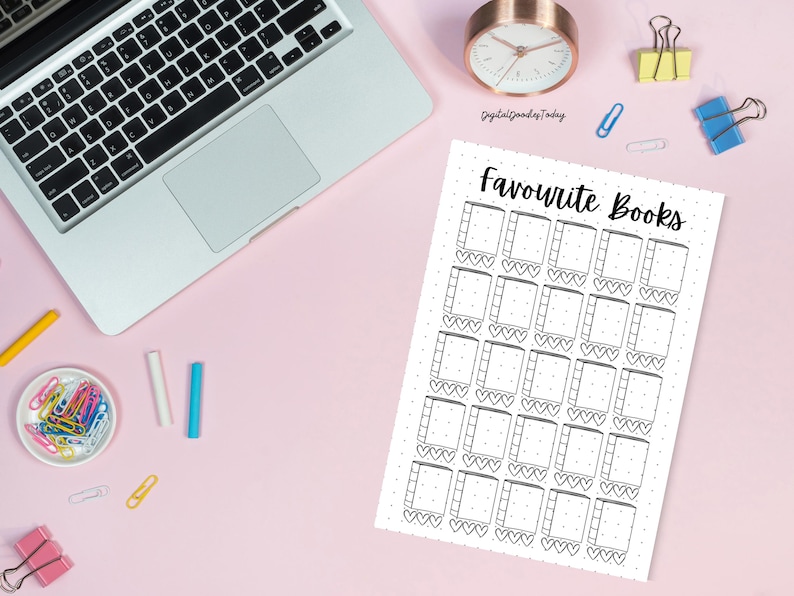 May include: A white paper with the text "Favourite Books" and a grid of book and heart illustrations. A laptop, clock, and office supplies are on a pink desk. The clock shows the time.
