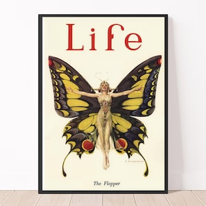 May include: A vintage magazine cover featuring a woman with wings, resembling a butterfly, against a white background. The magazine title "Life" is printed in red letters at the top. The text "The Flapper" is printed at the bottom.
