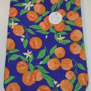 May include: A purple tote bag with a white strap and a white tag that says "Handmade just for you". The bag is decorated with a repeating pattern of orange citrus fruit and green leaves on a purple background.
