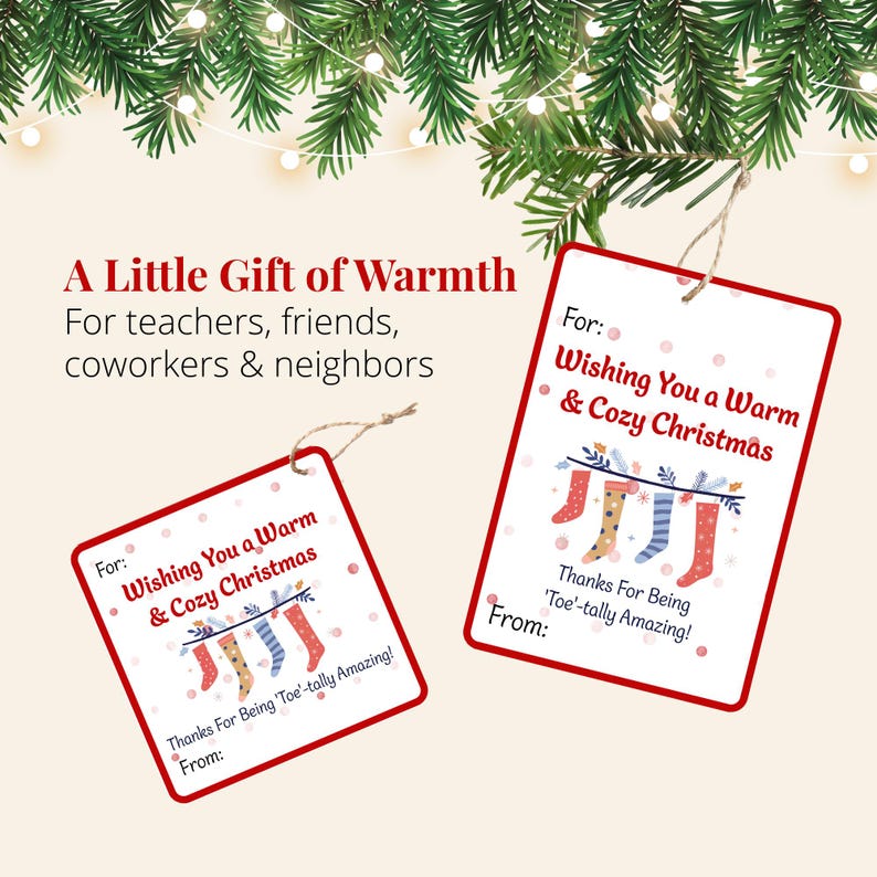 Two printable Christmas cozy sock gift tags displayed beneath evergreen branches and Christmas lights. The tags offer a thoughtful finishing touch for holiday sock gifts for teachers, friends, neighbors, and coworkers.