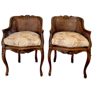 Pair of French Carved Walnut Louis XV Style Double Caned Armchairs