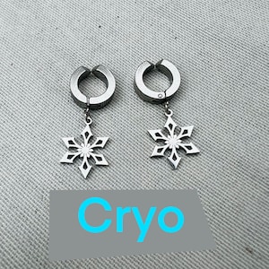 May include: A pair of silver snowflake earrings with a clip-on design. The earrings are made of metal and have a snowflake charm hanging from each clip. The word "Cryo" is written in blue text on a gray background.