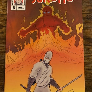 May include: Comic book cover featuring a ninja in a white outfit holding two swords, with a fiery background and a red figure. The title "Sukotto" is displayed in red, with "Studios" and issue number 6 visible.