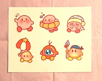 May include: A set of eight stickers featuring various characters from the Kirby video game series. The stickers are printed on white paper and feature a variety of colors, including pink, red, orange, yellow, blue, and green. The characters include Kirby, King Dedede, Meta Knight, Waddle Dee, and Bandana Dee.