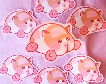 May include: A collection of seven stickers featuring a cartoon hamster design. The stickers have a white, pink, and orange color scheme, with pink wheels and rosy cheeks. The stickers are arranged on a pink surface.