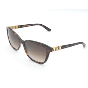 May include: Brown tortoiseshell sunglasses with gold accents and brown gradient lenses. The sunglasses have a Versace logo on the side.