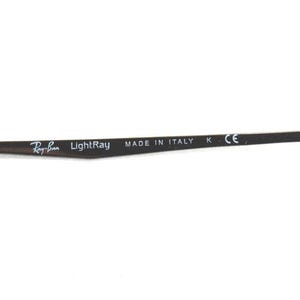 May include: Close-up of a dark brown eyeglass arm with the Ray-Ban LightRay logo and "MADE IN ITALY" text. The arm has a blue tip and the letters "K" and "CE" are also visible.