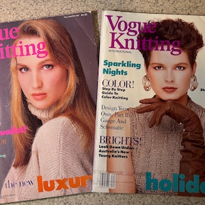 May include: Two vintage Vogue Knitting International magazines. The covers feature women with hairstyles and fashion from the 1980s. One magazine has the text "Luscious Mohair" and the other says "Sparkling Nights". The magazines are on a light gray surface.