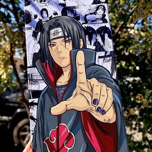 Op de afbeelding: Canvas art met een gedetailleerd anime-personage met zwart haar en rode ogen, dat vooruit wijst. De achtergrond bestaat uit zwart-wit manga-panelen. Het kunstwerk bevat een rood wolkensymbool en de handtekening van de kunstenaar.