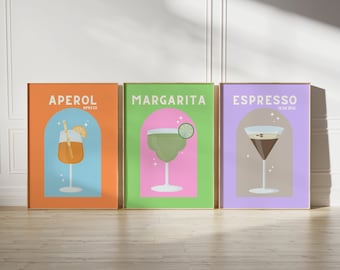 May include: Three framed prints with illustrations of cocktails. The first print is orange with a blue arch and features an Aperol Spritz. The second print is green with a pink arch and features a Margarita. The third print is purple with a brown arch and features an Espresso Martini.