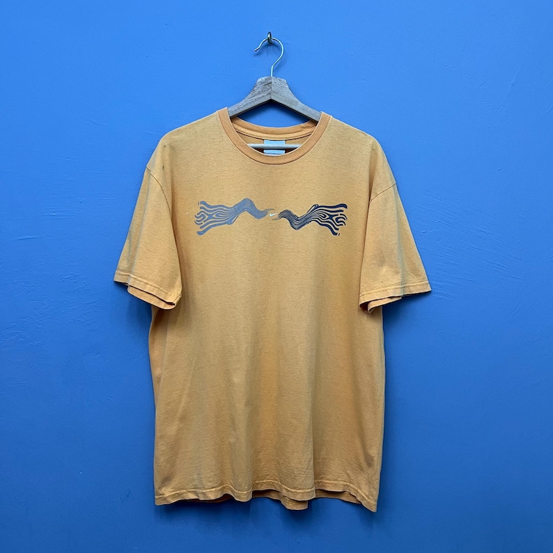 May include: A white ceramic mug with a black handle and the text "But First, Coffee" in a black, handwritten-style font. The mug is on a white surface.