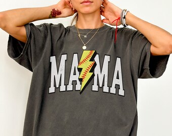 May include: A charcoal grey t-shirt with a white graphic of the word "MAMA" with a yellow lightning bolt and a softball inside the bolt.