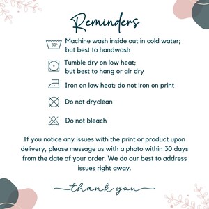 May include: A white informational card titled Reminders with dark teal text and icons. It lists garment care instructions: machine wash cold inside out, tumble dry low, iron on low heat avoiding the print, do not dry clean, and do not bleach.