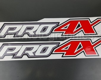 May include: Two white and gray "PRO 4X" decals with red lettering. The decals are on a white background.