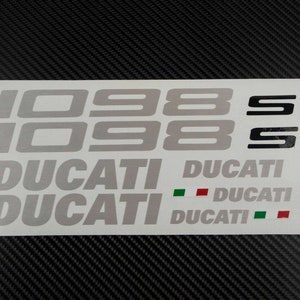 May include: A sheet of white vinyl stickers with the text "1098 S" and "DUCATI" in black and silver lettering. The Italian flag is also included in the sticker sheet.