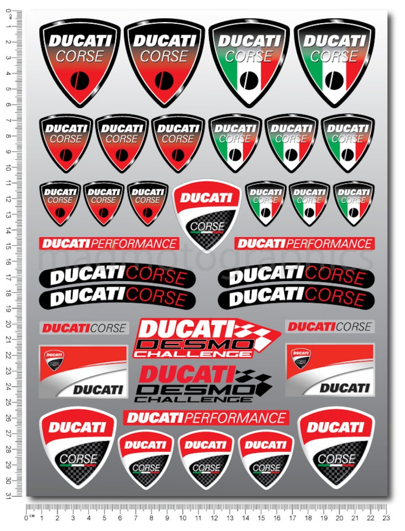 May include: A sheet of 23 red, white, and green motorcycle decals featuring the Ducati Corse logo. The decals are in various sizes and shapes, including shields, banners, and rectangles. The decals are printed on a white background.