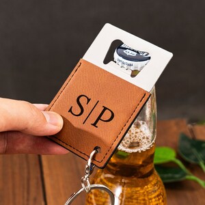 May include: A brown leather keychain with a bottle opener and a monogrammed "S|P".
