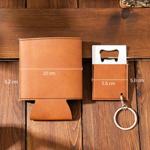 May include: A brown leather can cooler with a 9.2 by 10 inch measurement and a brown leather bottle opener with a 5.5 by 5.6 inch measurement and a silver key ring.