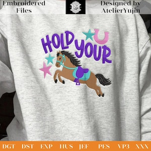 May include: A light grey sweatshirt featuring the embroidered words "HOLD YOUR" in purple, a brown horse with a purple saddle, and pink and teal stars. The text "Embroidered Files" and "Designed by Atelier Yujin" are also visible.