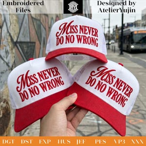 May include: White trucker caps with red peaks and the embroidered text "Miss Never Do No Wrong" in red script. The caps have a mesh back and a snap closure. The image also includes the text "Embroidered Files" and "Designed by AtelierYujin".