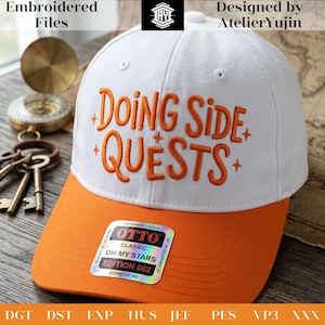 May include: A white baseball cap with an orange brim featuring the embroidered orange text "DOING SIDE QUESTS" with small star accents. A rectangular holographic sticker on the brim displays the text "OTTO CLASSIC OH MY STARS EDITION 002".
