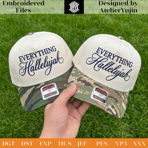 May include: Two beige baseball caps with camouflage visors. Each cap has the words "EVERYTHING Hallelujah" embroidered in navy blue. The caps are held against a green grass background. The caps are labeled "OTTO CLASSIC 210 MID PROFILE".