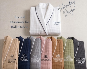 May include: A collection of waffle-weave robes in beige, blue, grey, pink, brown, sage green, and charcoal, each featuring embroidered text and logos. The robes are displayed with a white robe at the top, labelled with Custom Logo and Embroidery Design.
