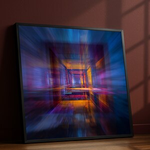 May include: Framed abstract art print featuring a vibrant, blurred perspective of a tunnel or corridor. The artwork showcases a dynamic interplay of colors, including blues, purples, oranges, and yellows, creating a sense of depth and movement. The black frame adds a modern touch.
