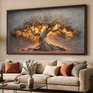 May include: A rectangular wall art piece featuring a textured, sculptural relief of a gnarled tree with intricate branches and roots. The artwork is framed in dark wood and illuminated from behind with a warm, golden light against a gray background.