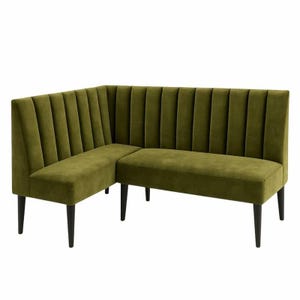 May include: Olive green corner sofa with a vertical channel tufted back and seat. The sofa has black legs and a modern design. The L-shaped seating arrangement is suitable for a living room or dining area.