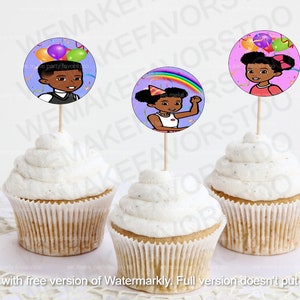 May include: Three cupcake toppers featuring cartoon children with colorful balloons and a rainbow. The toppers are on top of cupcakes with white frosting.