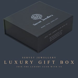 May include: A black luxury gift box with the text "Servet Jewellery" and "More Than Jewellery" on the top. The box also has the text "Join the Luxury Club with Us" and the website address "servetjewellery.com".