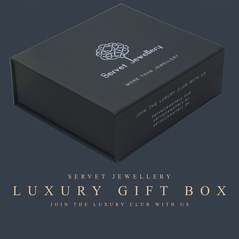 May include: A black luxury gift box with the text "Servet Jewellery" and "More Than Jewellery" on the top. The box also has the text "Join the Luxury Club with Us" and the website address "servetjewellery.com".