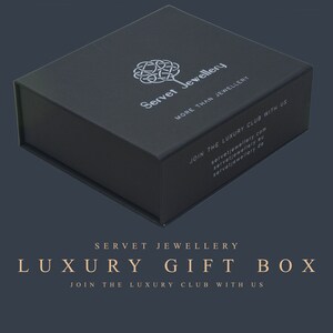 May include: A black luxury gift box with the text "Servet Jewellery" and "More Than Jewellery" on the top. The box also has the text "Join the Luxury Club with Us" and the website address "servetjewellery.com".