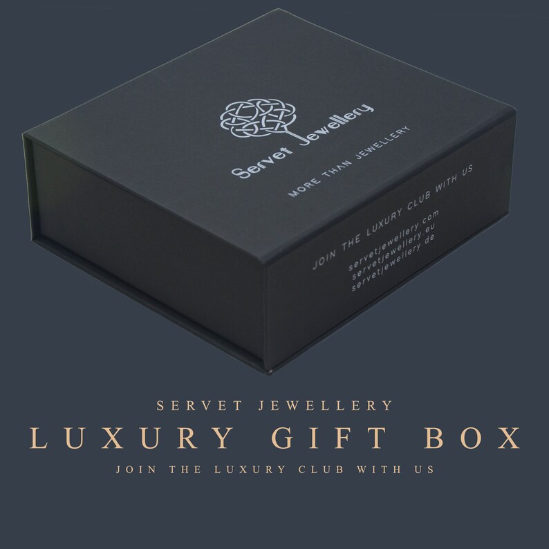May include: A black luxury gift box with the text "Servet Jewellery" and "More Than Jewellery" on the top. The box also has the text "Join the Luxury Club with Us" and the website address "servetjewellery.com".