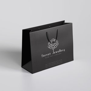 May include: Black shopping bag with a white logo that says "Servet Jewellery" and the tagline "More than Jewellery".