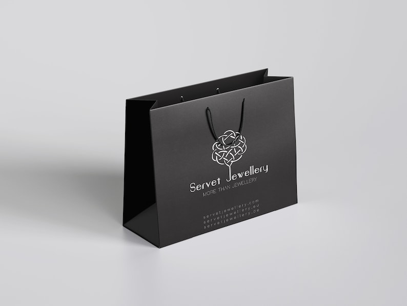 May include: Black shopping bag with a white logo that says "Servet Jewellery" and the tagline "More than Jewellery".